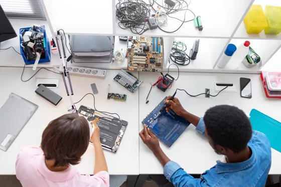 Hands wiring an electronics circuit