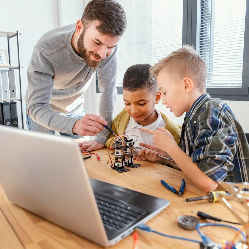 A father and his sons building a robot together