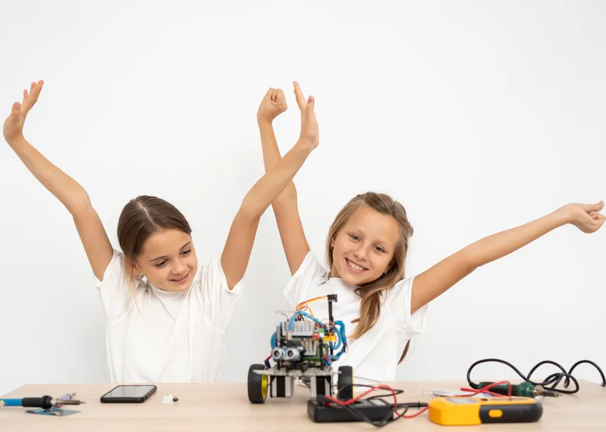 Smiling girls carrying out a science experiment together